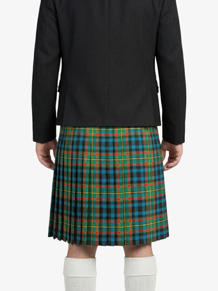 Person wearing a black jacket and plaid kilt on a white background
