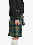 Person wearing a black jacket and green plaid kilt on a white background