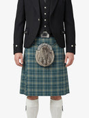 Person wearing a traditional Scottish kilt with a jacket on a white background