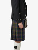 Person wearing a black jacket and plaid kilt on a white background