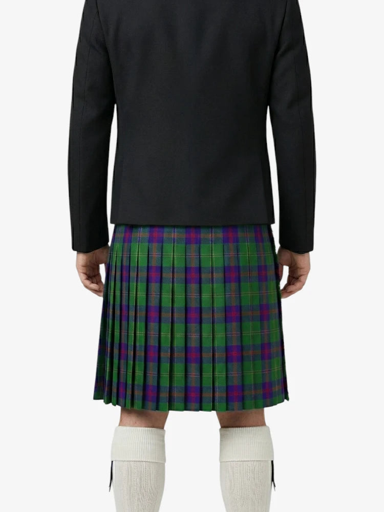 Person wearing a black jacket and green plaid kilt on a white background