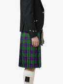 Person wearing a green plaid kilt with a black jacket on a white background