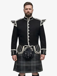 Man wearing a black doublet highland dress with white trim on a grey background