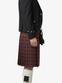 Person wearing a black jacket and red plaid kilt on a white background