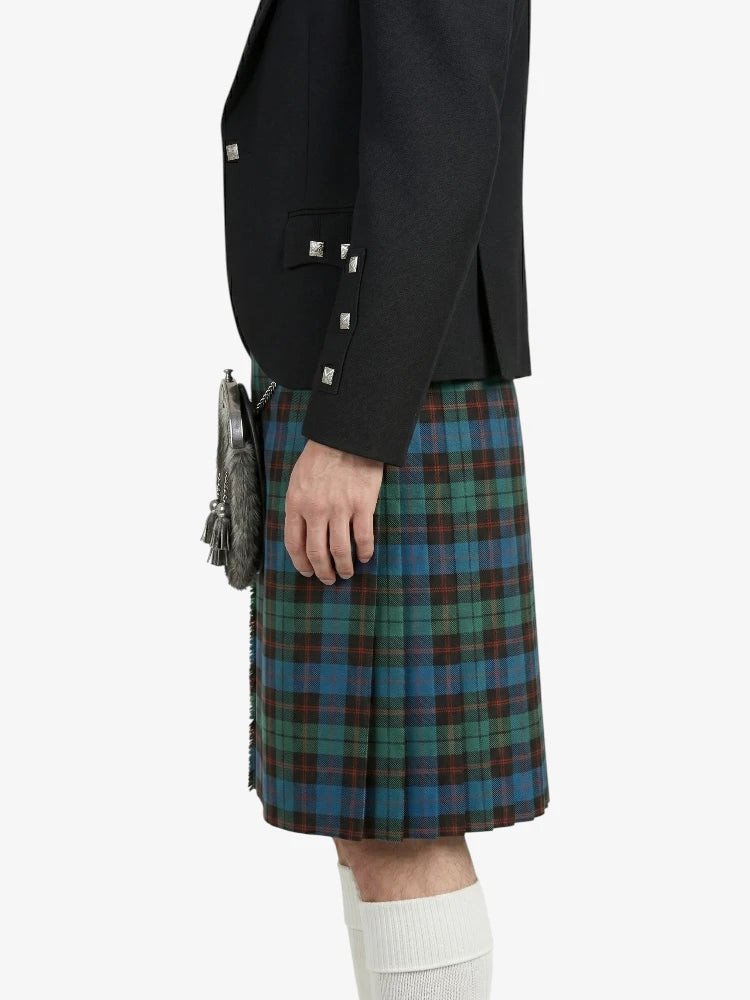 Person wearing a black jacket and plaid kilt on a white background