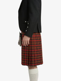 Person wearing a black jacket and red plaid kilt on a white background