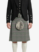 Person wearing a traditional Scottish kilt with a black jacket on a white background