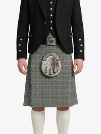 Person wearing a traditional Scottish kilt with a black jacket on a white background