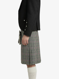 Person wearing a black jacket and plaid skirt on a white background