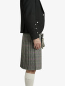 Person wearing a black jacket and plaid kilt on a white background