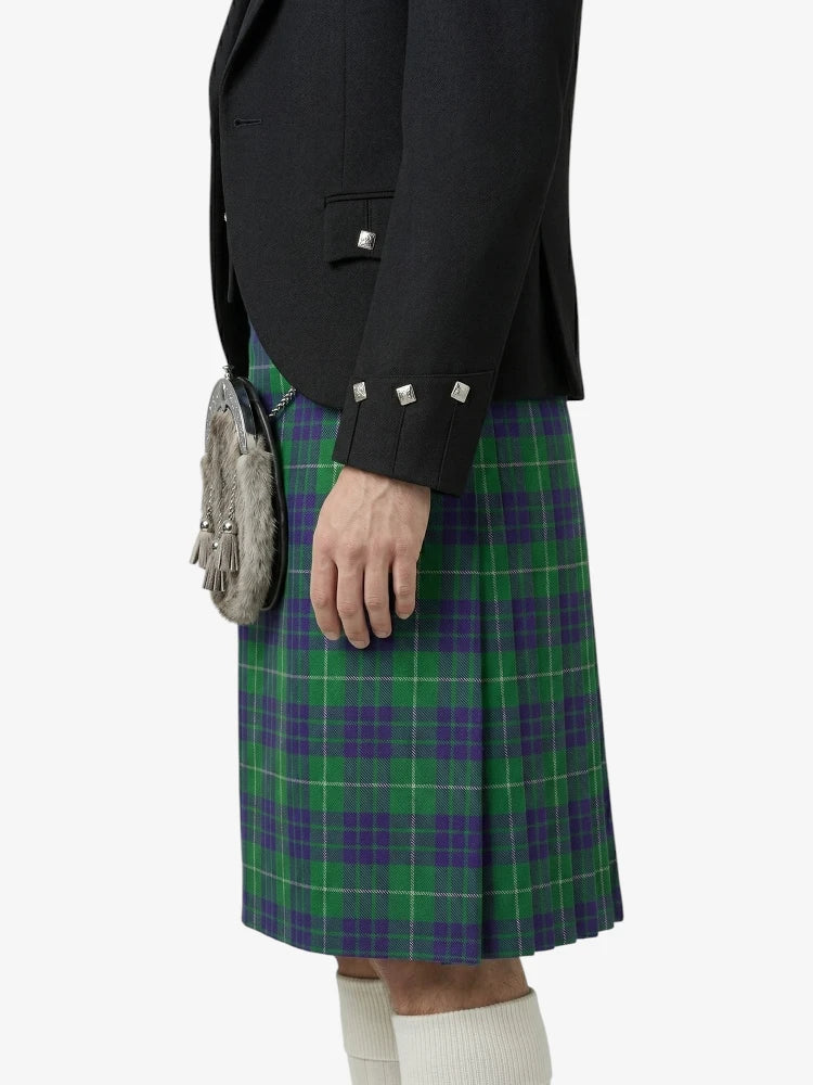 Person wearing a green and purple plaid kilt with a black jacket on a white background