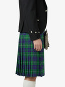 Person wearing a black jacket and green plaid kilt on a white background