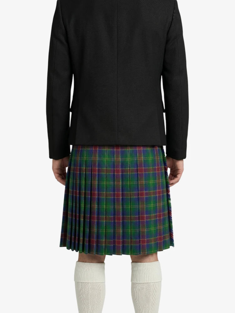 Person wearing a black jacket and green plaid kilt on a white background