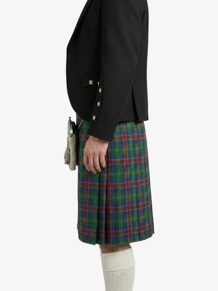 Person wearing a black jacket and plaid kilt on a white background