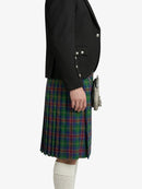 Person wearing a black blazer and plaid kilt on a white background
