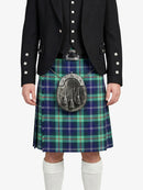 Person wearing a black jacket and green plaid kilt with a sporran on a white background