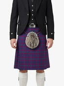 Person wearing a Scottish kilt with a tartan pattern on a white background