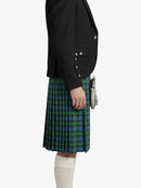 Person wearing a black blazer and blue plaid kilt on a white background