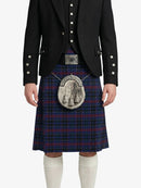 Person wearing a traditional Scottish kilt with a jacket on a white background