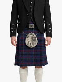 Person wearing a traditional Scottish kilt with a jacket on a white background