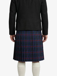 Person wearing a black jacket and plaid skirt on a white background