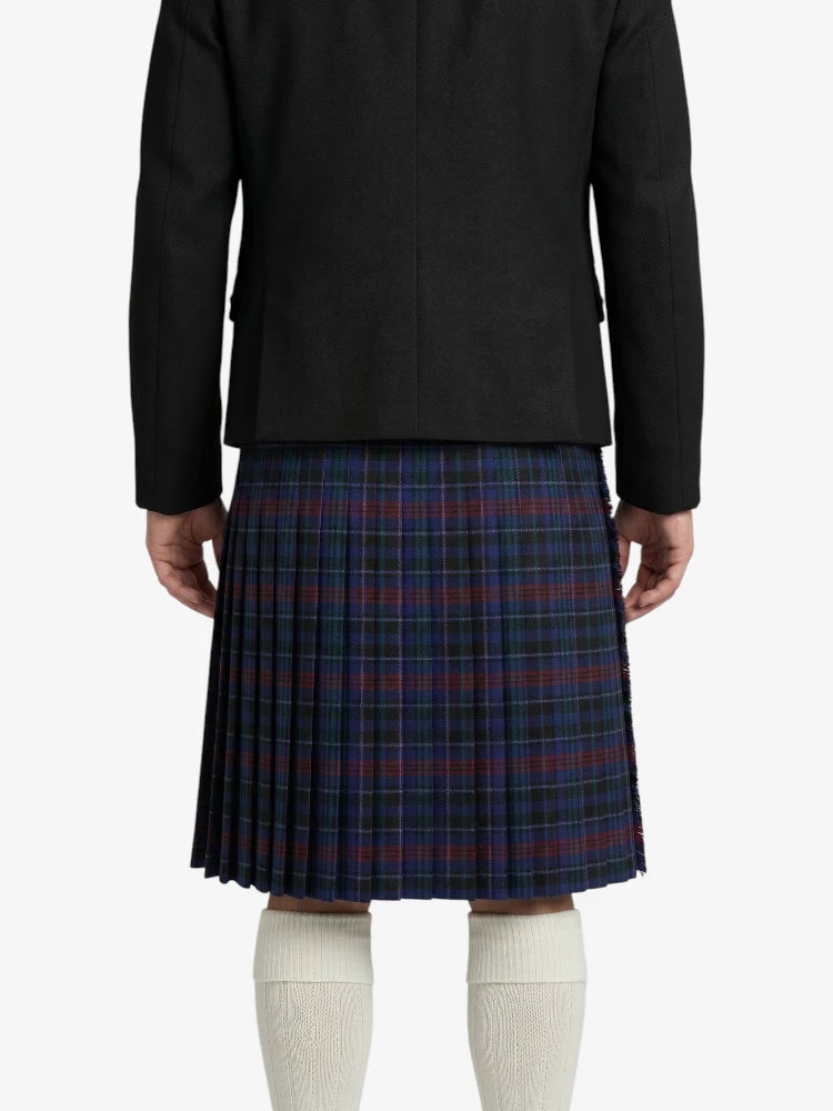 Person wearing a black jacket and plaid skirt on a white background