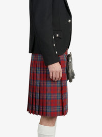 Person wearing a black jacket and red plaid kilt on a white background