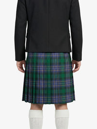 Person wearing a black jacket and green plaid kilt on a white background