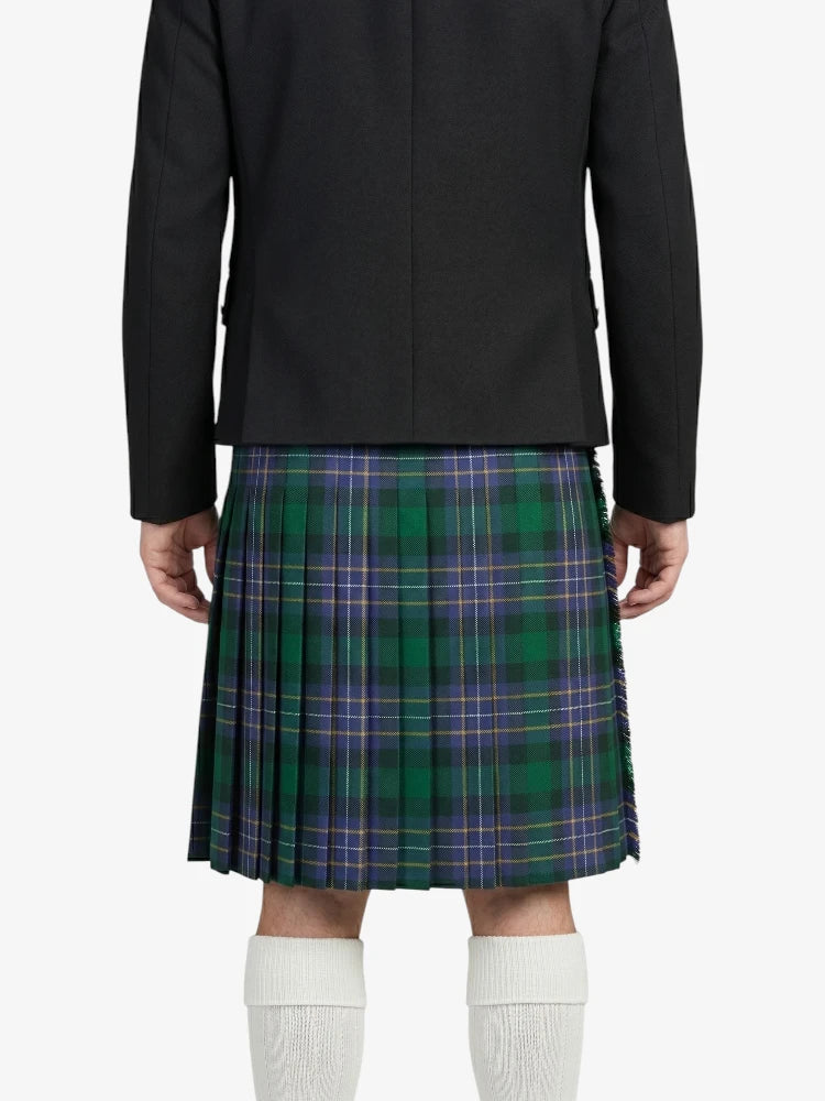 Person wearing a black jacket and green plaid kilt on a white background