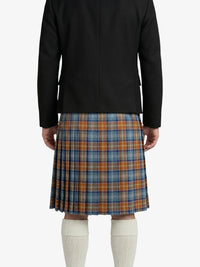 Person wearing a black jacket and plaid kilt on a white background