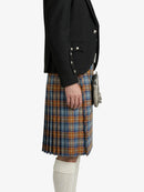 Person wearing a black jacket and plaid kilt on a white background