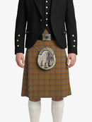 Person wearing a traditional Scottish kilt with a jacket on a white background