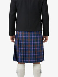 Person wearing a black jacket and blue plaid skirt on a white background