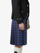 Person wearing a black jacket and blue plaid kilt on a white background