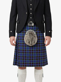Person wearing a traditional Scottish kilt with a tartan pattern on a white background