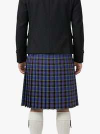Person wearing a black jacket and blue plaid kilt on a white background