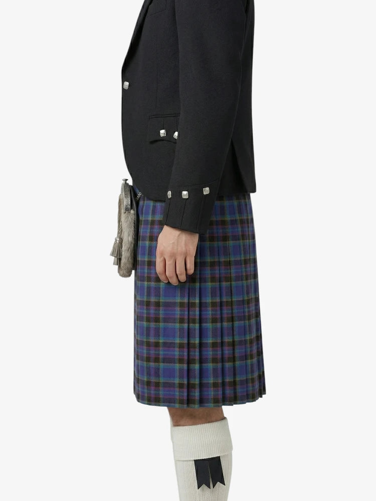 Person wearing a black jacket and blue plaid kilt on a white background