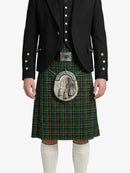 Person wearing a traditional Scottish kilt with a black jacket and white socks on a white background