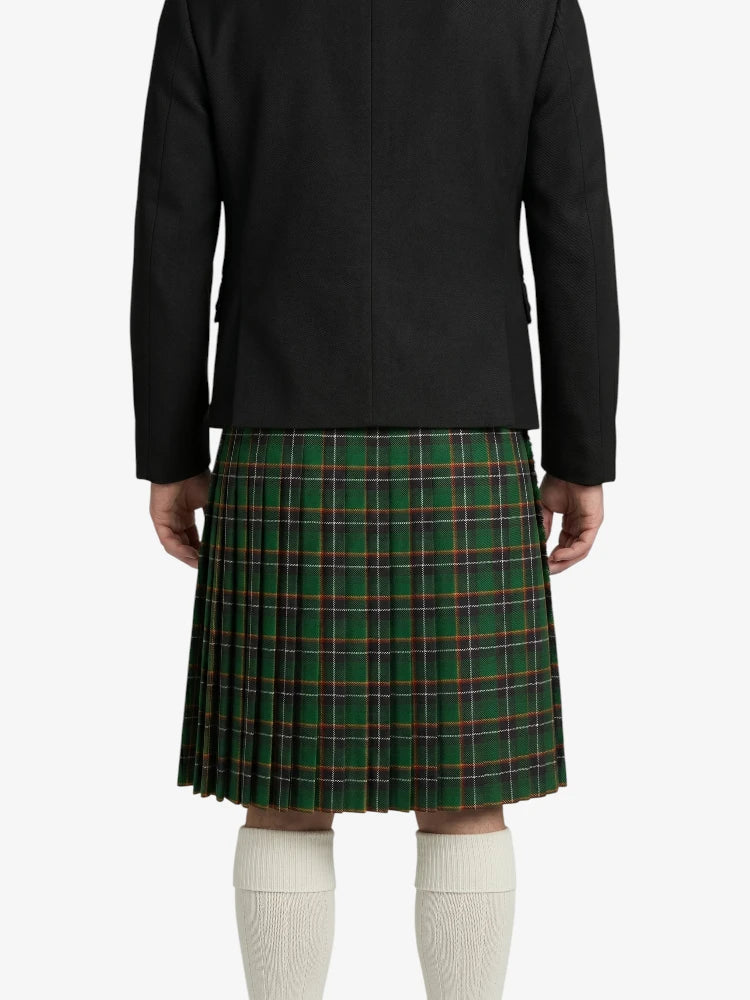 Person wearing a black jacket and green plaid kilt on a white background