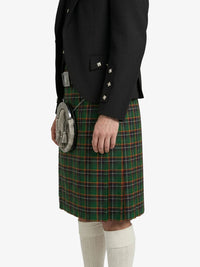 Person wearing a black jacket and green plaid kilt on a white background