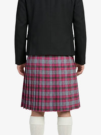Person wearing a black jacket and pink plaid kilt on a white background