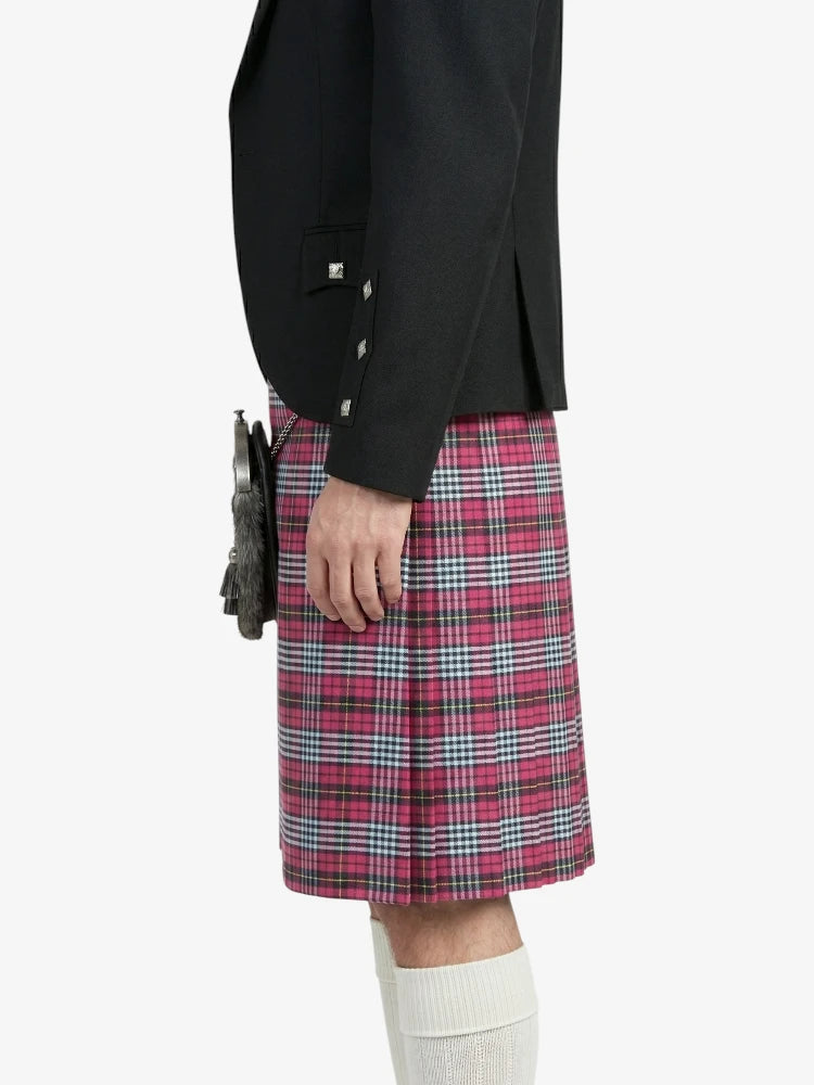 Person wearing a black blazer and red plaid kilt on a white background