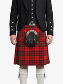 Person wearing a red tartan kilt with a black jacket on a white background
