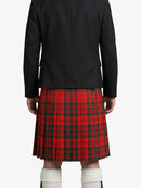 Person wearing a black jacket and red plaid kilt on a white background