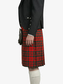 Person wearing a black jacket and red plaid kilt on a white background