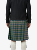 Person wearing a black jacket and green plaid kilt on a white background