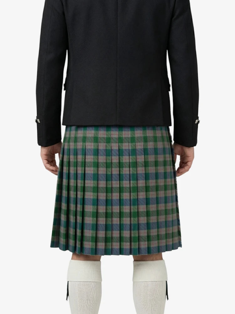 Person wearing a black jacket and green plaid kilt on a white background