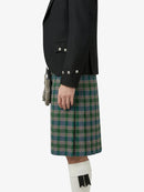 Person wearing a black jacket and green plaid kilt on a white background