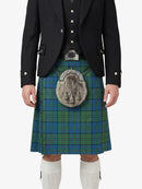 Person wearing a traditional Scottish kilt with a tartan pattern on a white background
