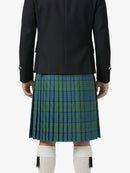 Person wearing a black jacket and green plaid kilt on a white background